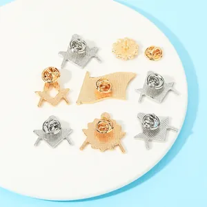 Freemason lapel pins set with gold and silver finish showing metal textures and butterfly clutch