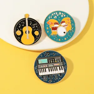 Detailed close-up of musical instrument enamel pins featuring guitar and drums
