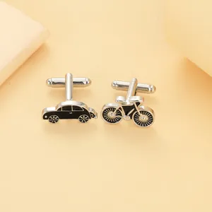 Detail of creative asymmetric car and bicycle cufflinks in polished silver and black enamel