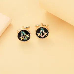 Macro shot of gold-plated Masonic cufflinks featuring black enamel and colorful rhinestones