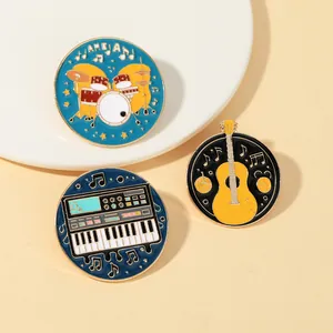 Detail of musical enamel pins featuring drums and guitar with gold metal edges