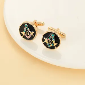 Macro shot of gold Masonic cufflinks with black enamel and multicolored rhinestones