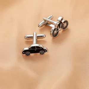 Detailed macro view of creative silver metal bicycle and vintage car cufflinks for men