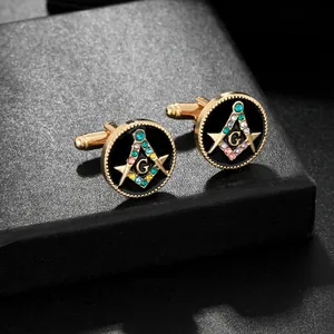 Macro detail of gold Freemasonry cufflinks with black enamel and multi-colored crystals