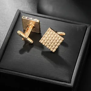 Elegant gold square cufflinks with geometric patterns and a premium black gift box