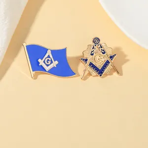 Detailed close-up of blue and gold Freemason enamel pins with compass and G logo