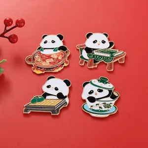 Macro detail of enamel panda pins featuring hot pot and mahjong themes on red background