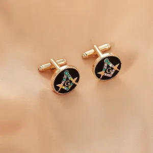 Macro shot of gold Masonic cufflinks with black enamel and rhinestones on satin