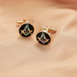 Detailed close-up of gold Masonic cufflinks with black enamel and colorful rhinestones