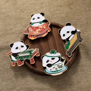 Macro shot of four cute panda pins showing mahjong and hotpot details on wood
