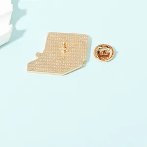 Back view of a gold pizza enamel pin with textured honeycomb finish and butterfly clutch