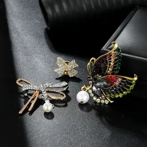 Detailed macro view of vintage butterfly brooches with colorful gems and pearls