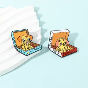 Detailed macro view of two puppy pizza enamel pins in light blue and white packaging