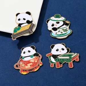 Detail of four creative metal panda pins playing mahjong and eating hot pot on blue fabric