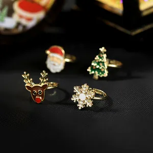 Detail of Christmas ring set featuring reindeer, Santa, and tree with enamel finish