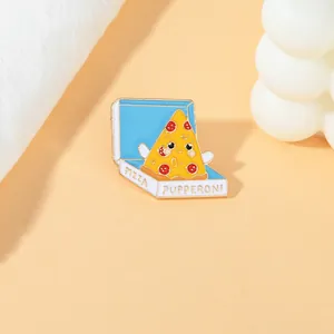 Detailed view of an enamel pizza box pin on an aesthetic light orange background