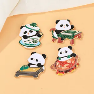 Close-up of four cute panda enamel pins featuring mahjong, hot pot, and tea designs