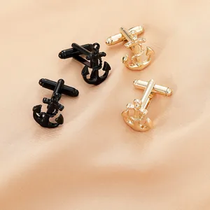 Detail of anchor cufflinks with rope texture in black and gold on pink silk