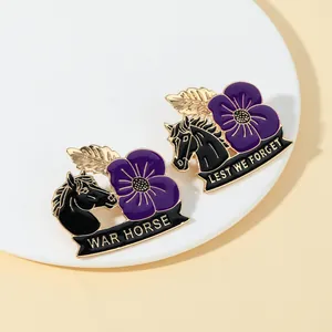 Close-up of War Horse enamel badge with purple poppy flowers and Lest We Forget engraving