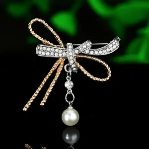 Detailed view of bicolor butterfly brooch with pave crystals and dangling pearl accent