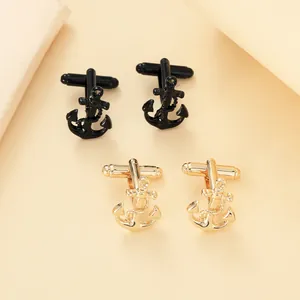 Detailed view of anchor cufflinks in polished black and gold finish for men's shirts