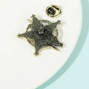 Back view of vintage star brooch with honeycomb texture and secure butterfly clutch