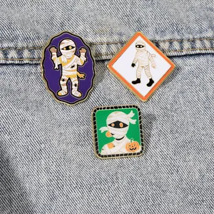 Set di tre spille in smalto mummia per Halloween, badge cartoon su sfondo di denim