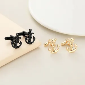 Detail of nautical anchor cufflinks in gold and black finishes with rope texture