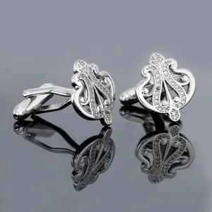 Luxurious silver crown-shaped cufflinks with white crystal pavé and hollowed design