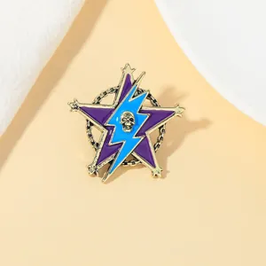 Detail of purple enamel star brooch featuring skull and lightning on gold metal base