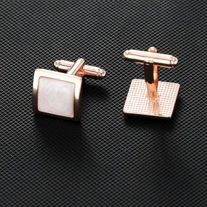 Elegant men's rose gold square cufflinks with white mother of pearl inlay on black background