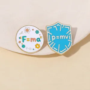 Detailed view of physics formula enamel pins featuring F=ma and p=mv scientific designs