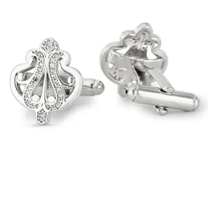 Silver crown-shaped cufflinks with inlaid diamonds for men's shirts on white background
