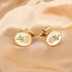 Detailed macro view of golden oval rose cufflinks on champagne satin fabric