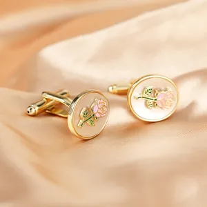 Detailed close-up of rose flower cufflinks on champagne satin fabric for luxury shirts