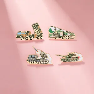 Detail view of DF-41 missile and tank military enamel pins set on a textured background