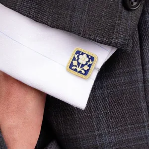 Elegant men's blue enamel flower cufflinks on a white shirt with grey plaid suit sleeve