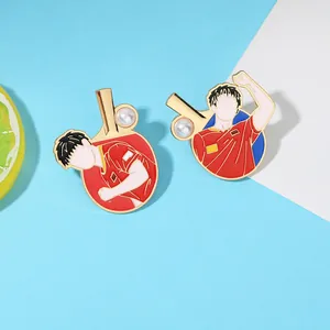 Detail of red enamel table tennis pins featuring athletes and faux pearl accents