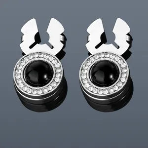 Detail of silver round cufflinks featuring a black onyx center and sparkling crystal pavé