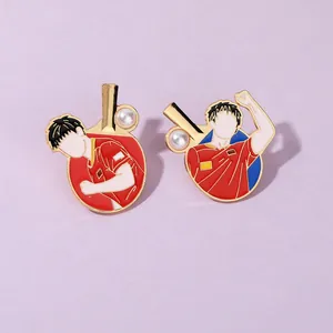 Detail of red and gold enamel table tennis pins featuring abstract athlete figures