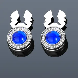 Detailed view of silver cufflinks with blue gemstone center and white crystal border