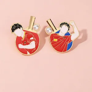 Detail of red enamel table tennis brooches with gold plating and pearl accents