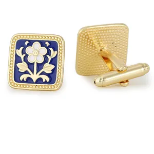 Golden square cufflinks with blue enamel, white flower pattern and bullet back closure