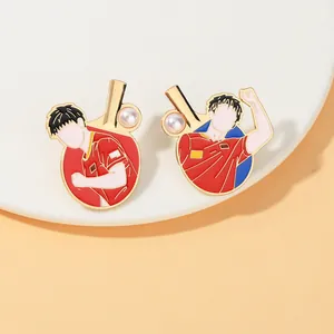 Detail of table tennis enamel pins featuring athletes in red kits with pearl accents