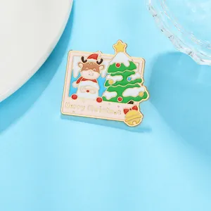 Detail of Christmas enamel brooch with Santa and deer motifs in a gold frame style