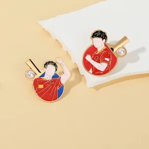 Macro detail of enamel table tennis badges featuring golden finish and athlete silhouettes