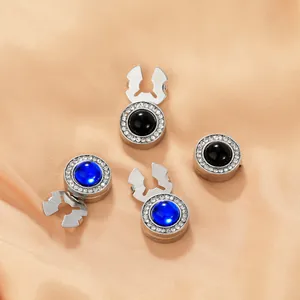 Detail of four sparkling rhinestone button covers on soft satin fabric for women dresses