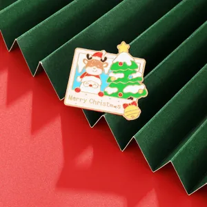 Detail view of colorful enamel Christmas reindeer and Santa brooch with a small golden bell
