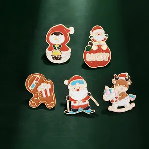 Detailed view of 5-piece set Christmas enamel pins with Santa and reindeer on green backdrop