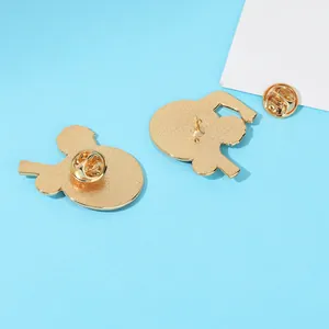 Back view of gold enamel pin badges showing butterfly clutch and metal needle structure